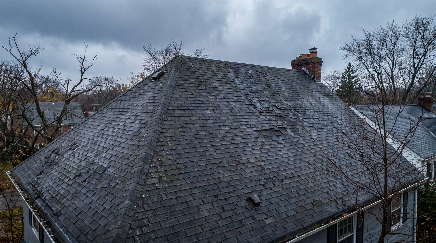 Aerial view of a steep-pitched Cleveland-area roof showing worn and displaced shingles